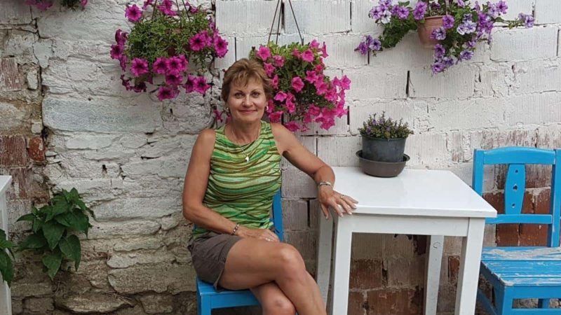 Lady sitting on chair in front of a Turkish şirince otel and restaurant