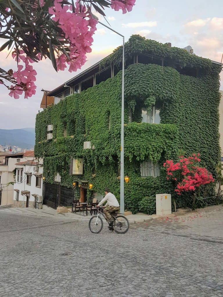 A cyclist on his bicycle on the cobbled street in town of Selçuk in Turkey