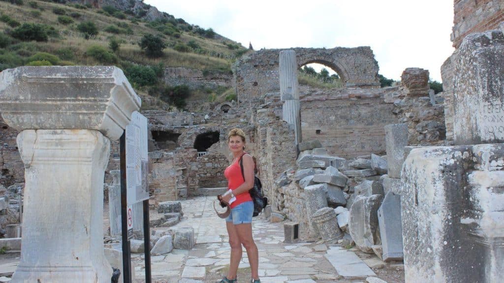 Woman in short and red top exploring Ancient Ephesus maps