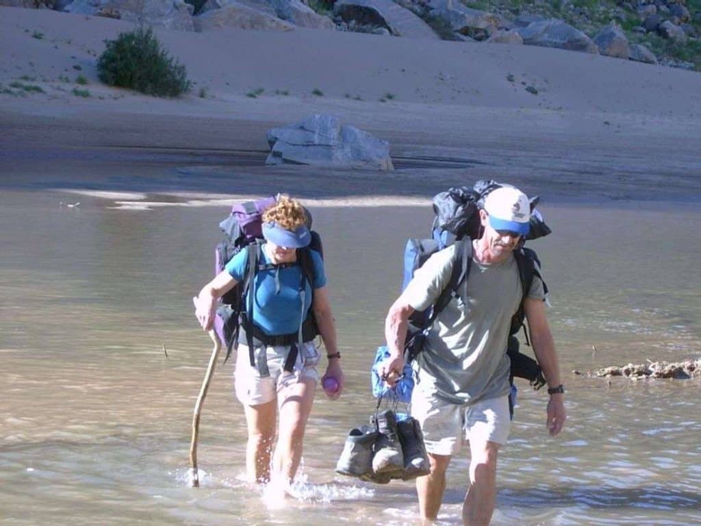 2 Hikers cross the River in Canyon