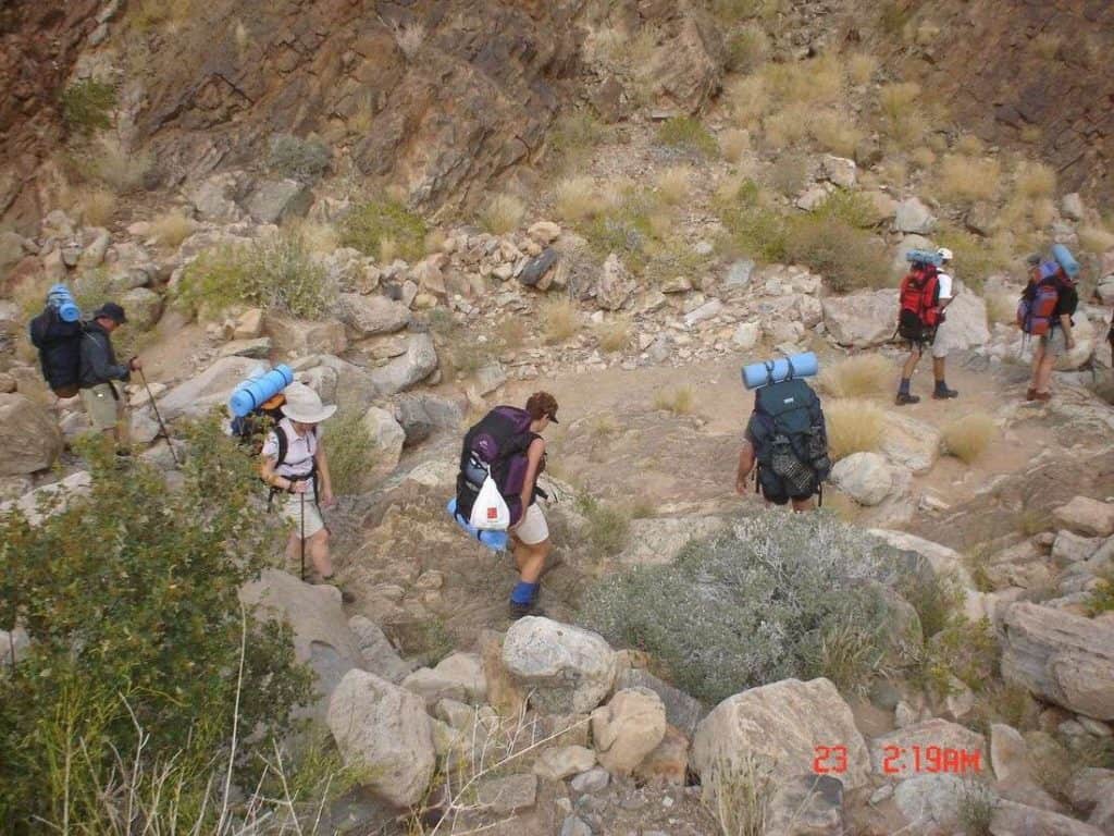 Group hikers descending down the canyon trail Namibia