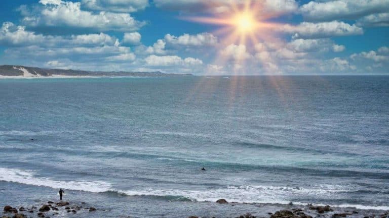 Surfers at Sunrise over Eastern Cape Beaches