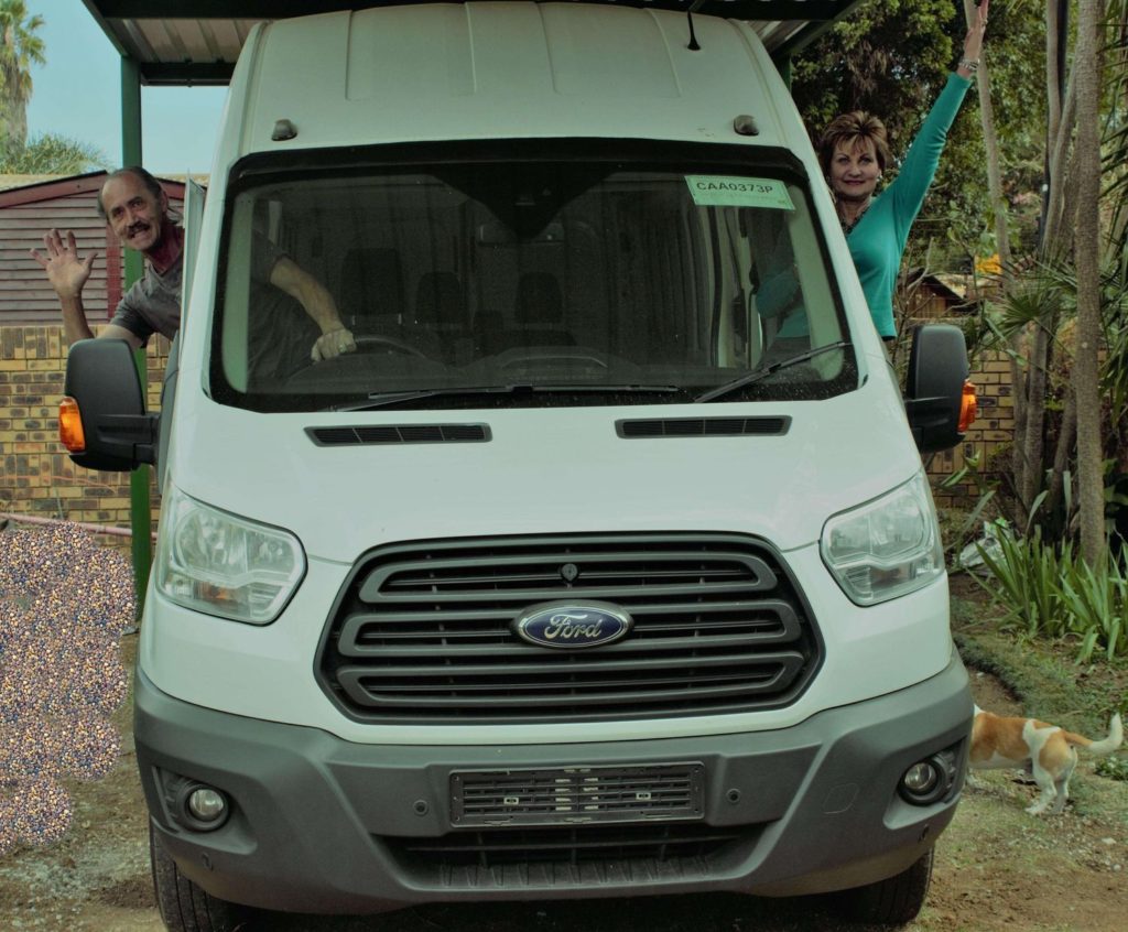 Couple with their converted White Ford Transit 2.2 TDCI Mobile home.
